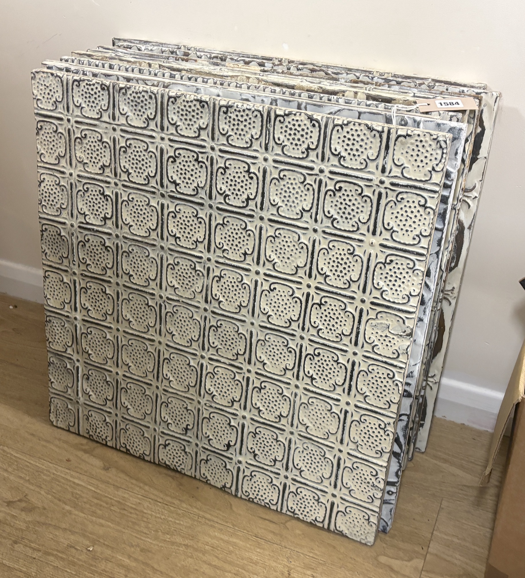 A group of nine decorative pressed tin panels made from salvaged antique tin ceilings, 59cm square